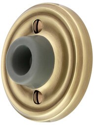 Wall-Mount Door Stop with Classic Rosette and Rubber Bumper in Antique Brass.